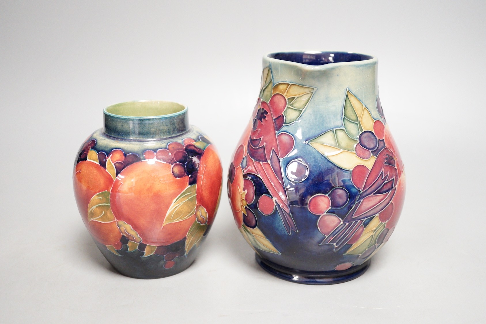 A Moorcroft finch and berry jug and a Moorcroft pomegranate jar, tallest 15cm